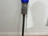 a vacuum that is sitting on the floor next to a wall