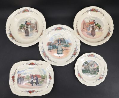 four plates with pictures of people on them sitting on a table