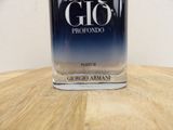 a bottle of perfume sitting on a wooden table