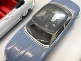 several toy cars are lined up in a row on a white surface
