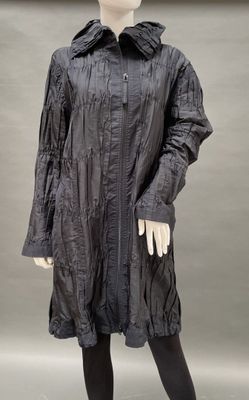 an image of a mannequin dressed in a black coat and black tights