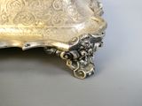 a silver plate with a handle on it on a table
