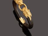 a gold and hornwood bracelet, by person
