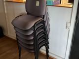 a stack of chairs sitting on top of each other in a room
