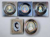 four framed portraits of women and children are hanging on a wall