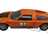 an orange toy car that is connected to a computer mouse