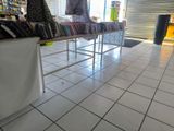 a white tiled floor in a store with a table full of books