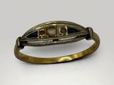 an antique gold ring with sapphires and diamonds on a white background