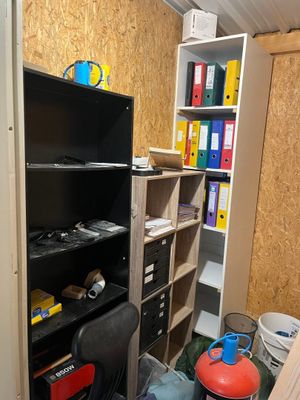 une pièce dans laquelle se trouvent une bibliothèque, une chaise et une borne d'incendie
