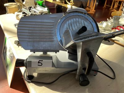 a large slicer sitting on a table in a kitchen
