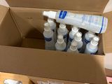 a cardboard box filled with bottles of water and a bottle of toothpaste