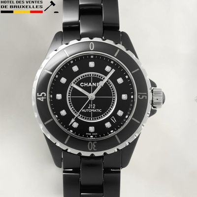 a black watch with white numbers on the face of it