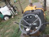 un tracteur qui est garé dans l'herbe près d'une clôture