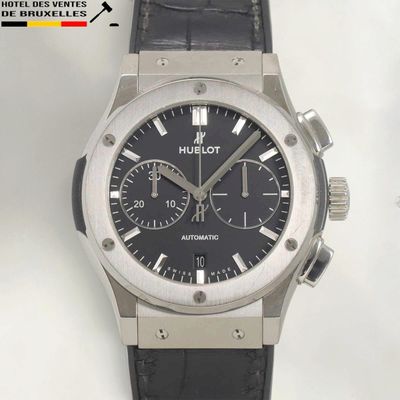 a watch with a black dial on a black leather strap