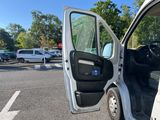 a white van parked in a parking lot with its door open