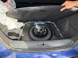 a sub in the trunk of a car with a speaker in it