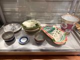 many plates and bowls sitting on a table