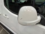 an image of a side view mirror of a white van