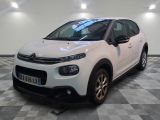 the white citrole is parked on a checkered tile floor