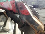 a tractor that is parked on the side of the road