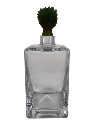 clear glass bottle with a small green plant inside of it