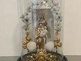a glass dome with a statue inside of it on a table