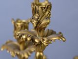 a close up of a gold candle holder on a table
