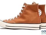a close up of a pair of brown converses on a white background