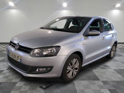 the silver volkswagen polo is parked in a room with checkered floor