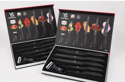 pair of knives in a black box with red trimmings