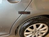 a sticker on the side of a silver car