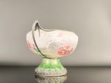 a glass bowl with a hook on top of it