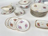 many plates and cups and saucers on the table