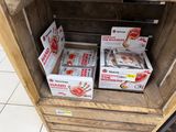 several boxes of food are stacked on top of a wooden crate