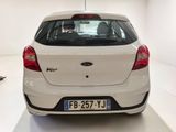 a white car that is parked in a white room