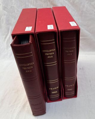 three red books are stacked on top of each other on a white surface