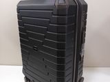 a black suitcase sitting on a white surface