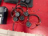 a lot of headphones that are sitting on a table