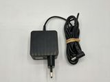 a black charger with a cord attached to it on a white surface