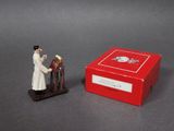 a small figurine of a man with a box of flowers