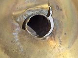 a metal sink with a hole in the middle of it