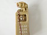 a small statue of a dog on top of a box