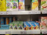 many drinks and juices on the shelves in the store