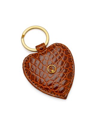 a close up of a heart shaped keychain on a white background