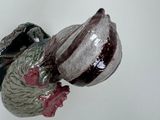 a figurine of a rooster that is hanging on a wall
