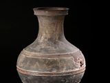 a vase that is sitting on a black surface