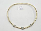 a gold and silver necklace with a small bead on it