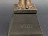 bronze statue of a woman ' s feet on top of a pedestal