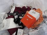a pile of clothing and other items on a bed