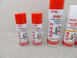 three sprays of spray paint are sitting next to each other on a table